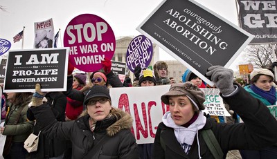 
              Anti-abortion activists and supporters of legal abortion stand in front of the Supreme Court in Washington, Friday, Jan. 25, 2013, on the 40th anniversary of the Roe v. Wade decision.  